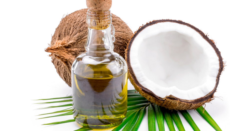 Kokosnuss und Öl in Glasflasche